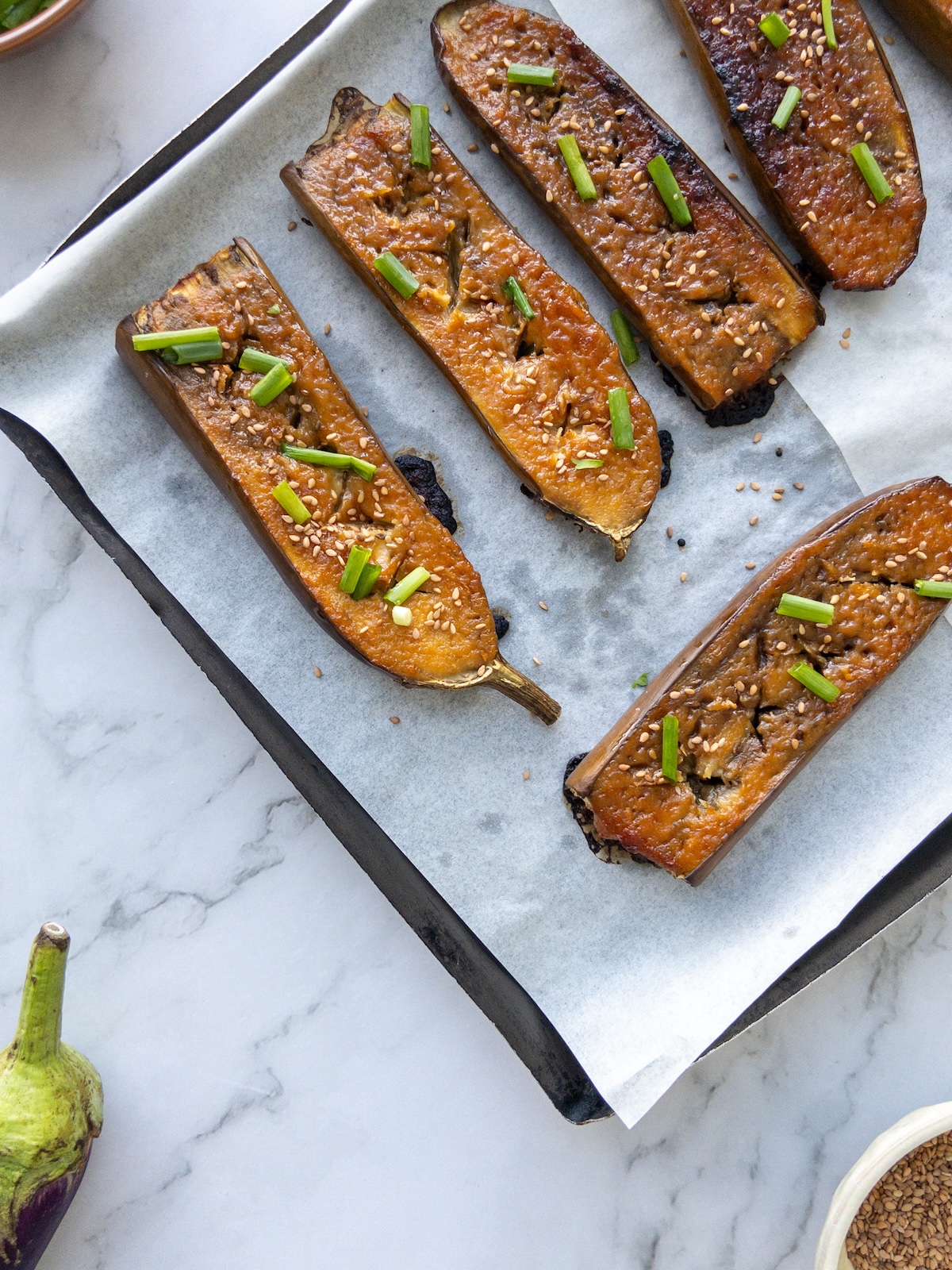 Sticky aubergines topped with green onions.