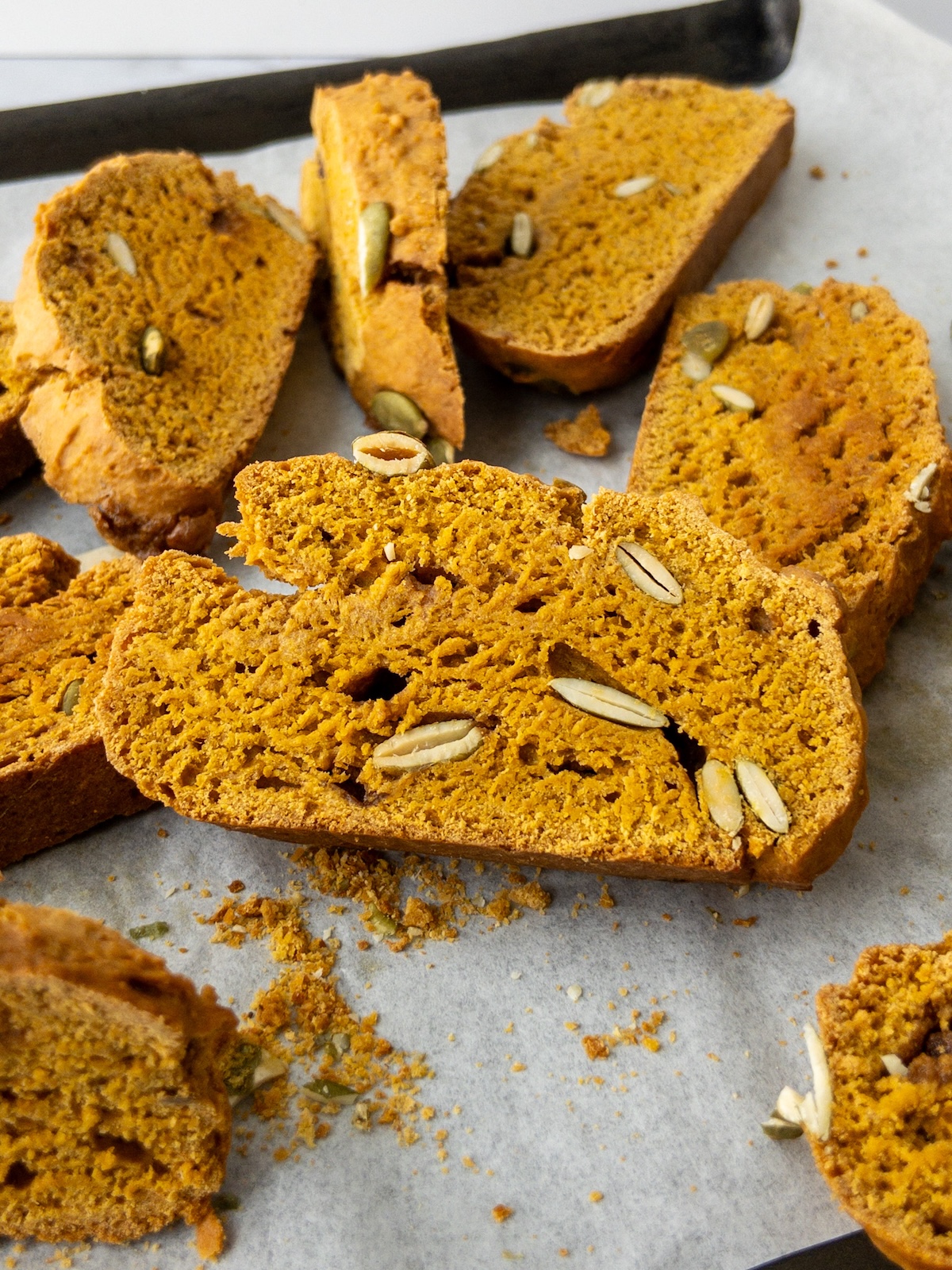 Pumpkin Biscotti laid out on baking paper in a tray
